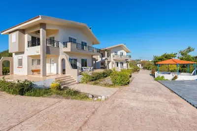 a row of houses next to the water at Piccolo Paradiso Villas in Gennadi