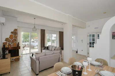 a living room with a couch and a table at Piccolo Paradiso Villas in Gennadi