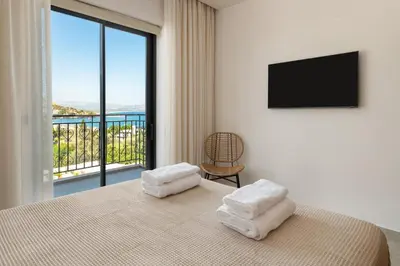 a bedroom with a bed and a large window at Villa Celestia in vlicha