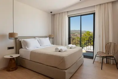a bedroom with a bed and a large window at Villa Celestia in vlicha
