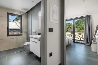a bathroom with a toilet and a sink at Rokas Luxury Villas in Asgourou