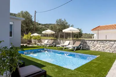 a backyard with a swimming pool and grass at Villa Ceroni in vlicha