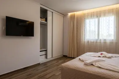 a bedroom with a bed with a television and a window at Villa Ceroni in vlicha