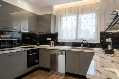 a kitchen with stainless steel appliances and a window at Villa Ceroni in vlicha