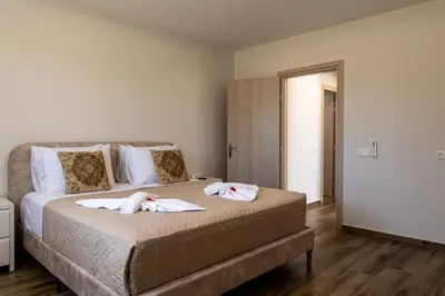 a bedroom with a bed with two towels on it at Villa Ceroni in vlicha