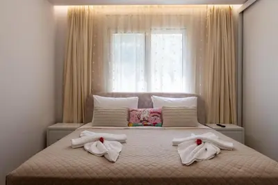a bedroom with towels on a bed with a window at Villa Ceroni in vlicha