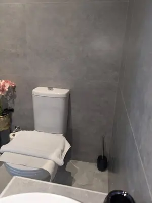 a bathroom with a white toilet and a sink at Nirea Tree View Studio in Faliraki
