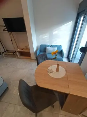 a dining room table with a vase on top of it at Nirea Tree View Studio in Faliraki
