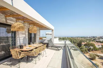 a patio with a table and chairs on a balcony at Rodos Nest with terrace and seaview in Asgourou