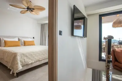 a bedroom with a bed and a ceiling fan at Rodos Nest with terrace and seaview in Asgourou