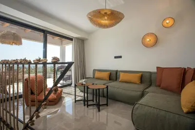 a living room with a couch and a table at Rodos Nest with terrace and seaview in Asgourou
