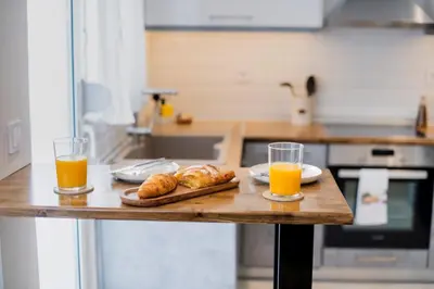 a table with two glasses of orange juice and croissants at Acropolis Gem in Rhodes Town