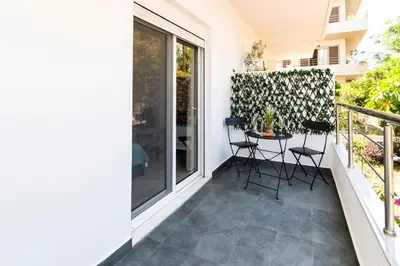 a patio with chairs and a table on a balcony at Acropolis Gem in Rhodes Town