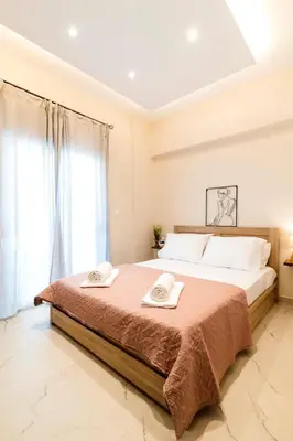 a bedroom with a large bed with two towels on it at Acropolis Gem in Rhodes Town