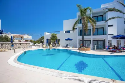 a large swimming pool in front of a building at Moscha Hotel in Faliraki