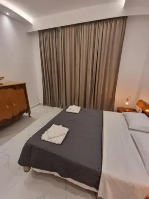 a bedroom with a bed with two towels on it at City center beach house in Rhodes Town