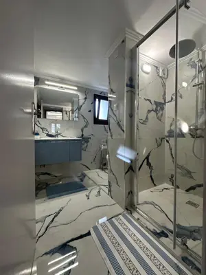 a bathroom with a shower and a sink and a mirror at City center beach house in Rhodes Town
