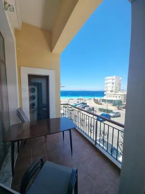 a balcony with a table and a view of the beach at City center beach house in Rhodes Town