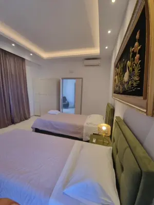 a hotel room with two beds and a couch at City center beach house in Rhodes Town