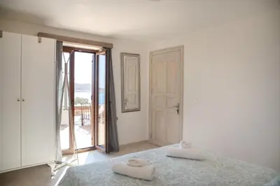 a bedroom with a bed with two towels on it at Villa Aristoteles in Halki