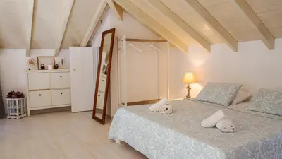 a bedroom with a bed and a dresser at Villa Aristoteles in Halki