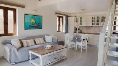 a living room with a couch and a table at Villa Aristoteles in Halki
