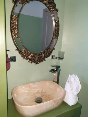 a sink in a bathroom with a mirror at St Paul's Studios Chrysanthi in Líndos