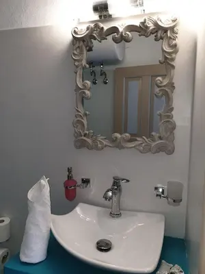 a bathroom with a white sink and a mirror at St Paul's Studios Chrysanthi in Líndos