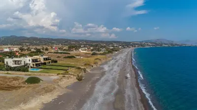 an aerial view of a beach with houses and the ocean at Great Sand Villa in Gennadi