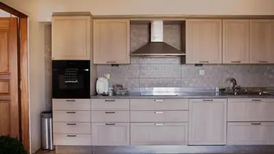 a kitchen with white cabinets and a sink at Belvedere private luxury beach villa in Halki