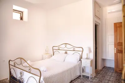 a white bedroom with a white bed and a window at Belvedere private luxury beach villa in Halki