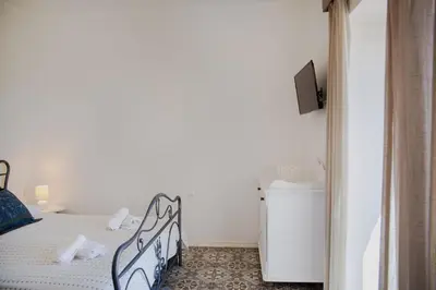 a bedroom with a bed and a small refrigerator at Belvedere private luxury beach villa in Halki