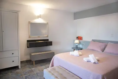 a bedroom with a bed with two towels on it at Villa Romanza beach villa in Halki
