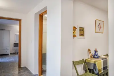 a dining room with a table and a table and chairs at Villa Romanza beach villa in Halki