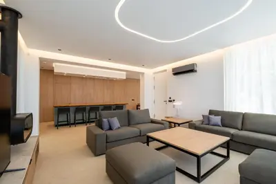 a living room with two couches and a television at Vista by Del Sol Villa in Rhodes Town