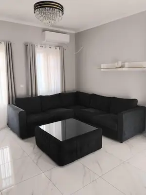 a living room with a black couch and a coffee table at Anasa house in Symi