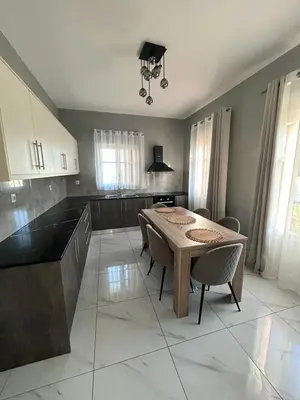 a kitchen with a table and chairs in a room at Anasa house in Symi
