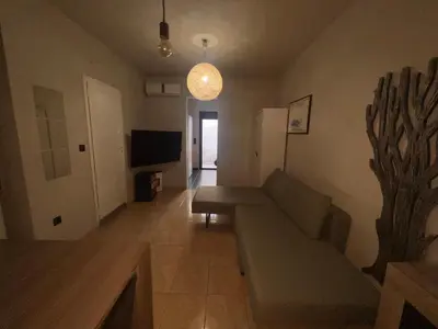 a living room with a couch and a tv at Princeps De Cura Rhodes in Ialyssos