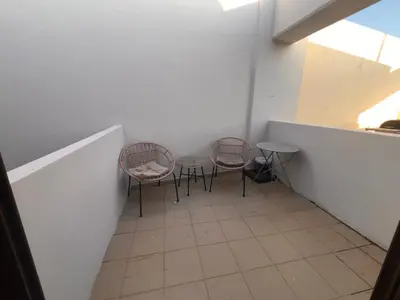 two chairs and a table in a room at Princeps De Cura Rhodes in Ialyssos