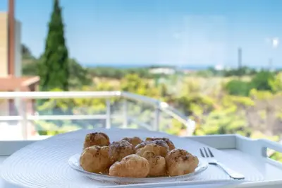 a plate of donuts sitting on a table at ''Aetheria'' Rooftop Resort with sea view in Kremasti
