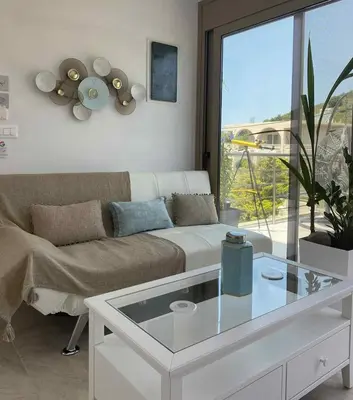 a living room with a couch and a glass table at ''Aetheria'' Rooftop Resort with sea view in Kremasti
