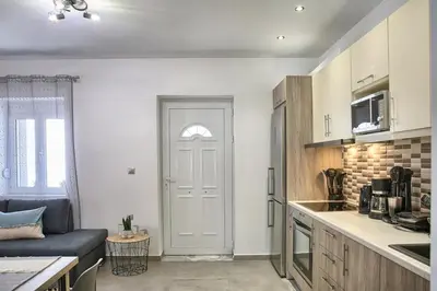 a kitchen with a white door in a room at Haraki Acqua e Sole Ground Floor House in Haraki