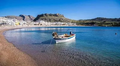 a boat sitting on the shore of a beach at Haraki Acqua e Sole Ground Floor House in Haraki