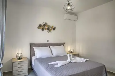 a bedroom with a bed with two white towels on it at Haraki Acqua e Sole Ground Floor House in Haraki