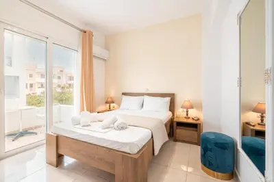 a bedroom with a bed and a large window at Elias Apartments with View in Rhodes Town