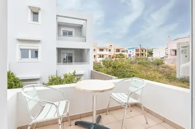 a balcony with a table and two chairs and a view at Elias Apartments with View in Rhodes Town