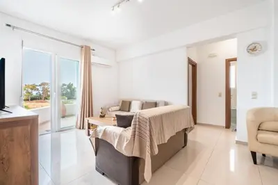 a living room with a couch and a tv at Elias Apartments with View in Rhodes Town
