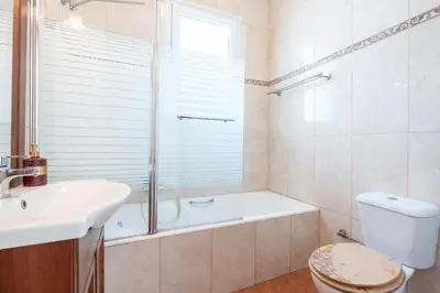 a bathroom with a tub and a toilet and a sink at Elias Apartments with View in Rhodes Town
