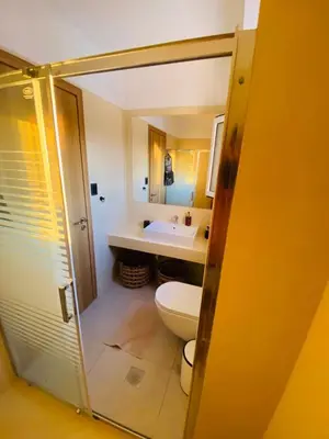 a bathroom with a toilet and a sink at Casa Evita in Gennadi
