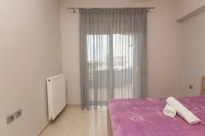 a bedroom with a purple bed and a window at Mary Luxury House in Émbonas